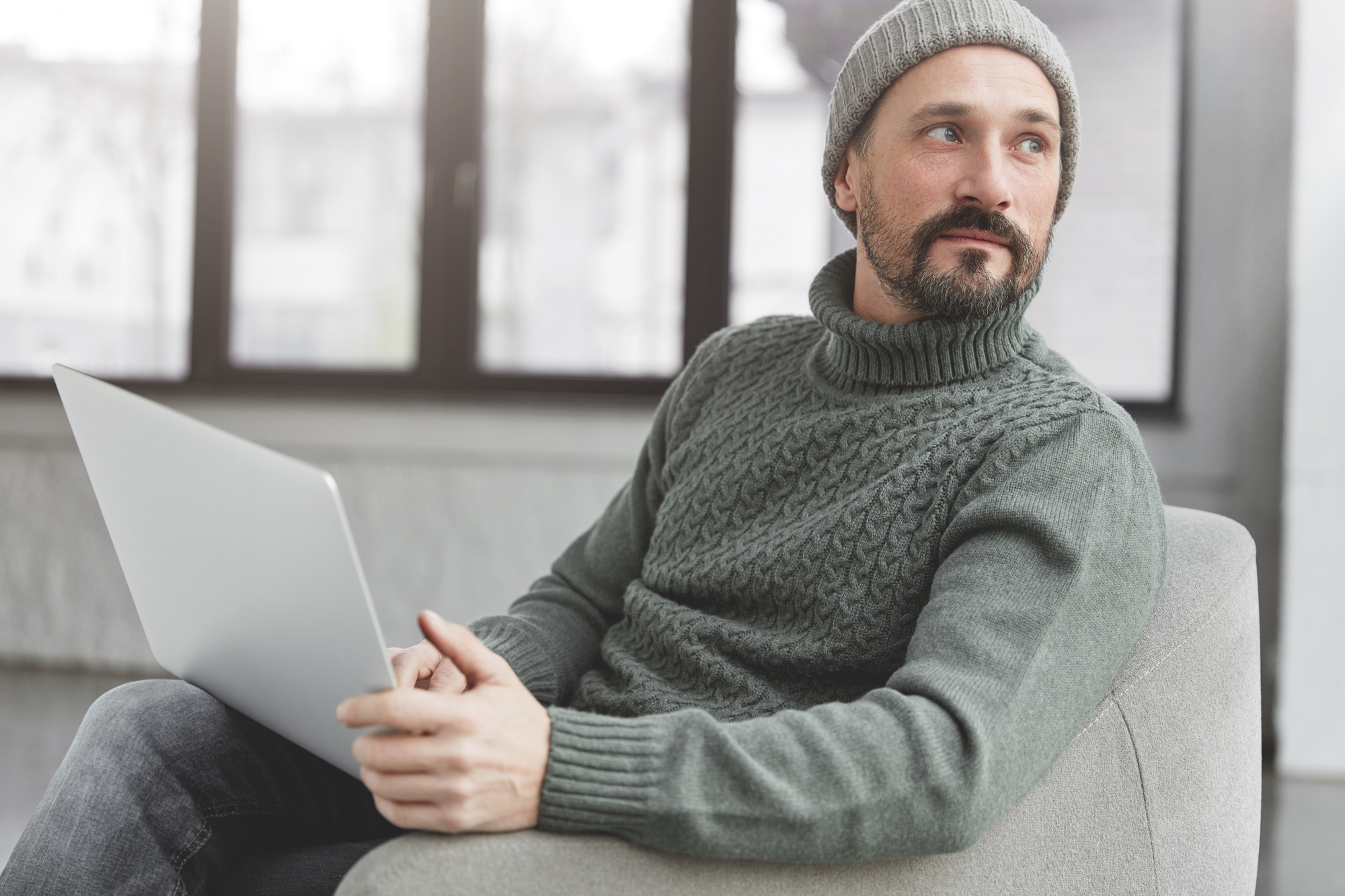 Professional marketing expert browses information on internet websites, uses laptop computer and wir