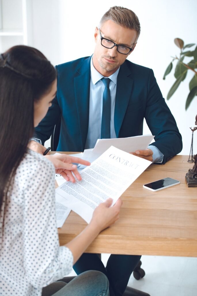 male lawyer looking at client reading contract